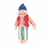 Nanchen pop Helena, licht blond mohair haar, wit-groen gestreepte lange broek, rood en wit gestreepte t-shirt met lange mouwen, roos kraagje, rode wollen bodywarmer en donkerblauwe wollen muts.