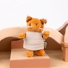 Mrs.Squirrel standing on her bed in her dollhouse.